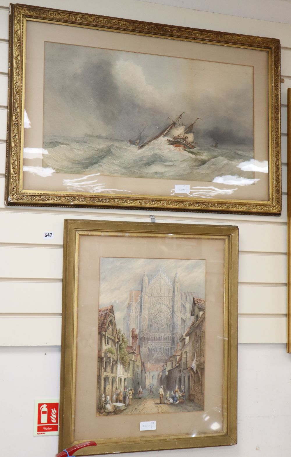 H.F. Neave, watercolour, Fishing boats in a rough sea, signed and dated 85, 39 x 69cm and a watercolour view of a cathedral by another